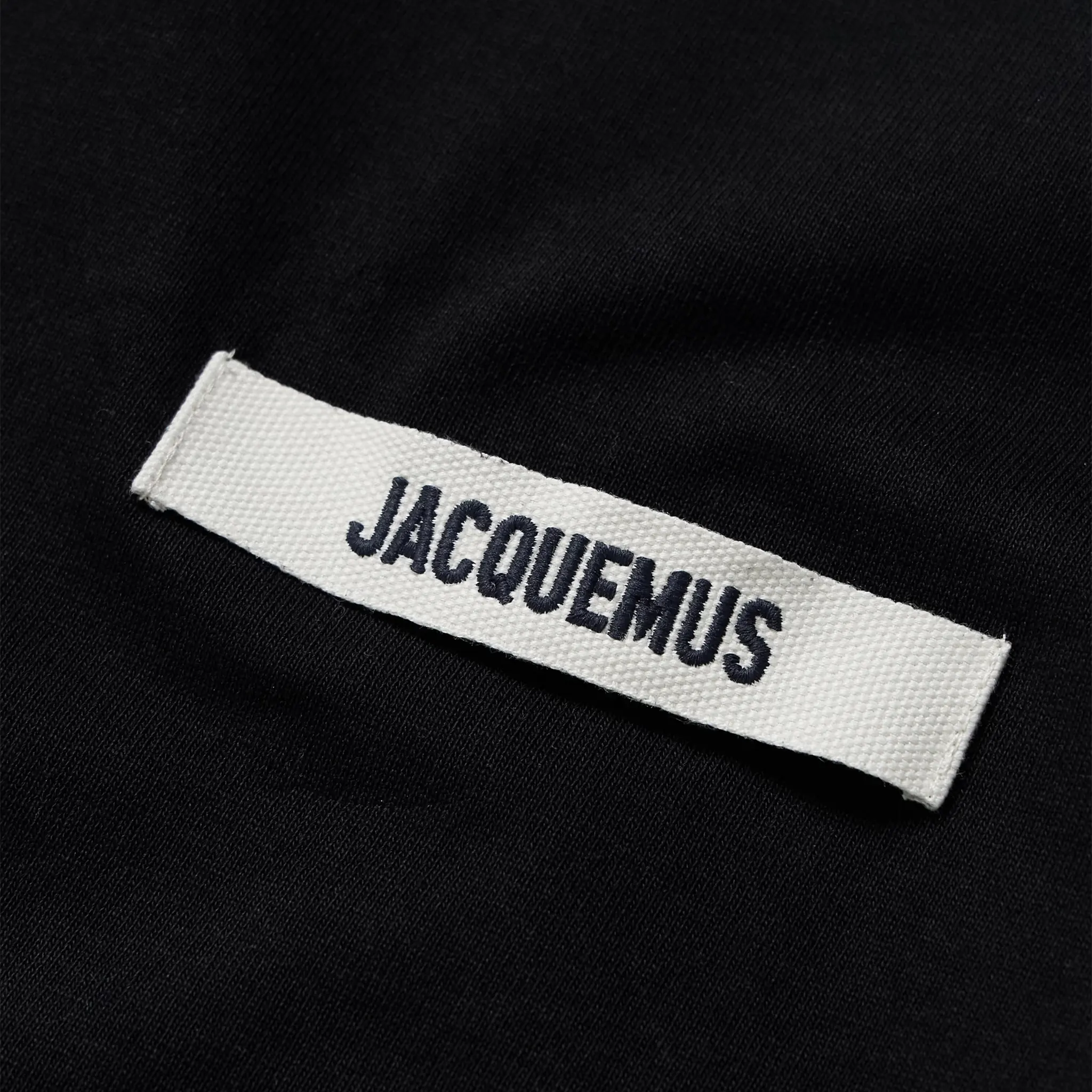 Detail view of Jacquemus Grosgrain Brand Logo Tab Black T Shirt 245JS208-2125-990